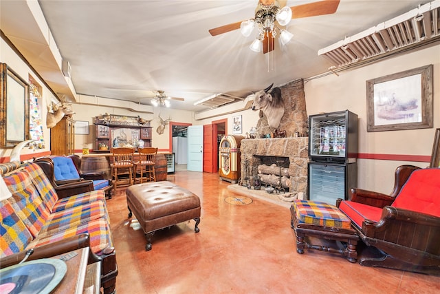 living room with ceiling fan and a stone fireplace