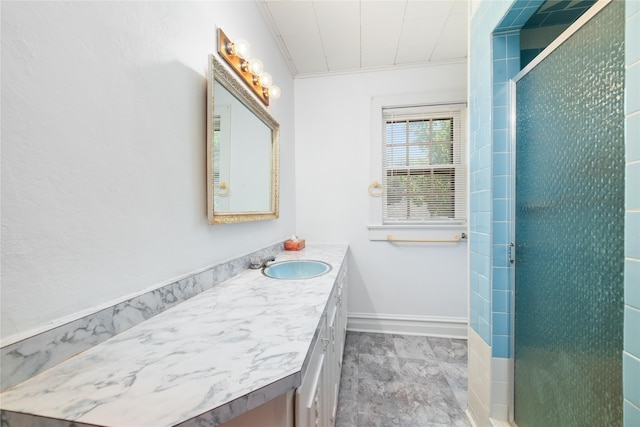 bathroom featuring an enclosed shower, vanity, and crown molding