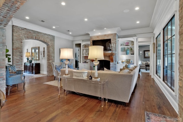 living room featuring wood-type flooring and ornamental molding