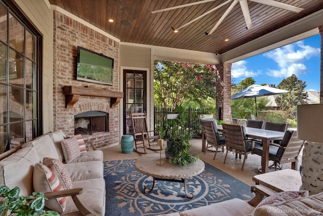 view of patio / terrace featuring an outdoor brick fireplace