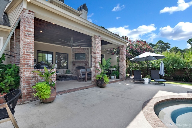 view of patio featuring ceiling fan and a hot tub