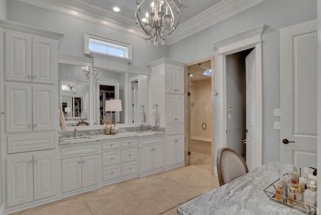 bathroom featuring a notable chandelier, tile patterned floors, a shower with shower door, ornamental molding, and vanity