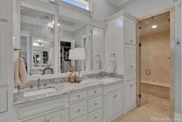 bathroom with tile patterned flooring, an enclosed shower, a notable chandelier, crown molding, and vanity