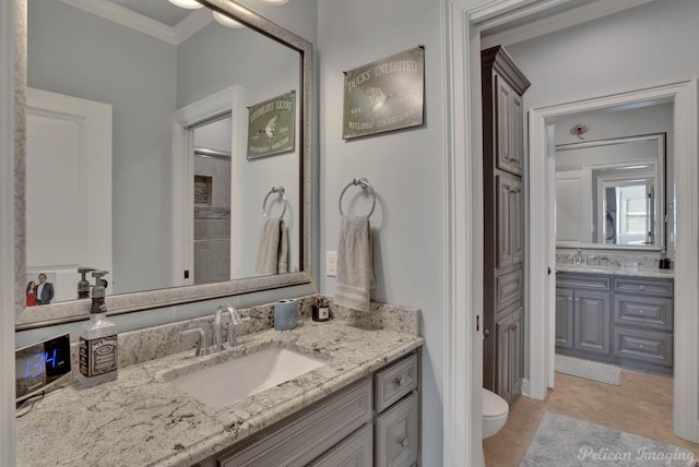 bathroom with ornamental molding, tile patterned flooring, vanity, and toilet