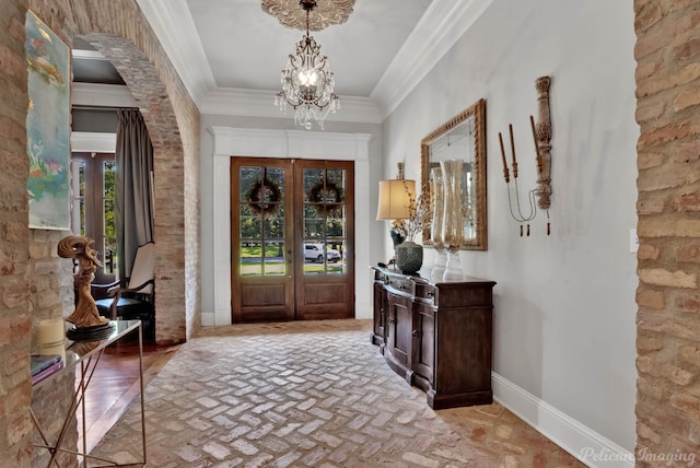 entrance foyer featuring french doors and crown molding