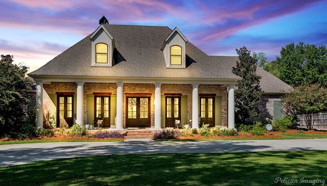 view of front of property featuring a lawn and covered porch