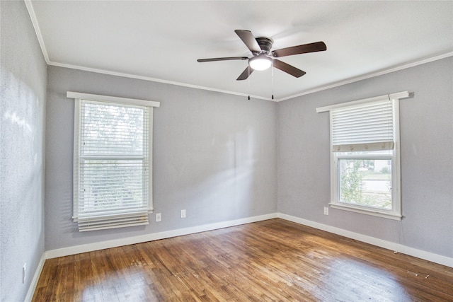 empty room featuring hardwood / wood-style flooring, crown molding, ceiling fan, and a wealth of natural light