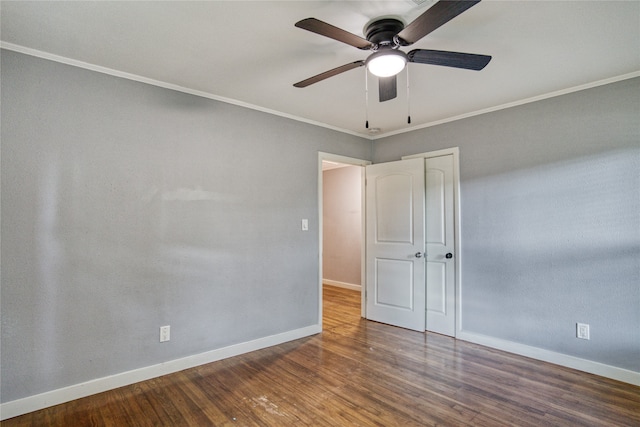 unfurnished room with ceiling fan, dark hardwood / wood-style floors, and ornamental molding