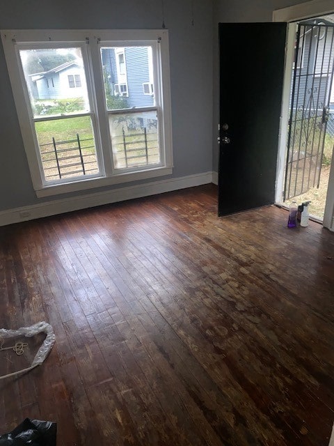 spare room with dark wood-type flooring