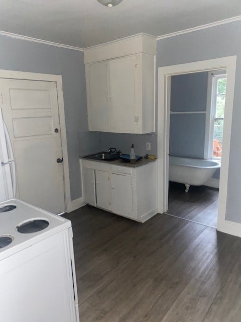 kitchen featuring ornamental molding, sink, dark wood-type flooring, white cabinetry, and electric range