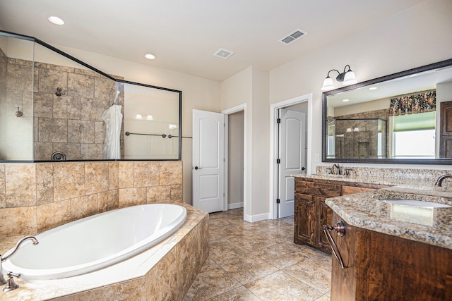 bathroom featuring vanity and plus walk in shower