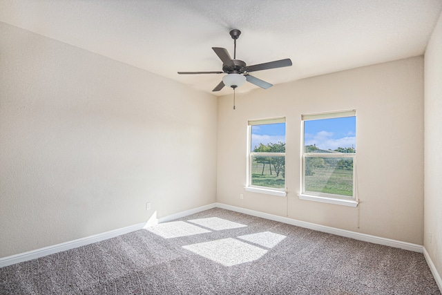 empty room featuring carpet floors and ceiling fan