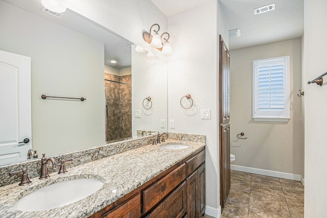 bathroom featuring walk in shower, vanity, and toilet