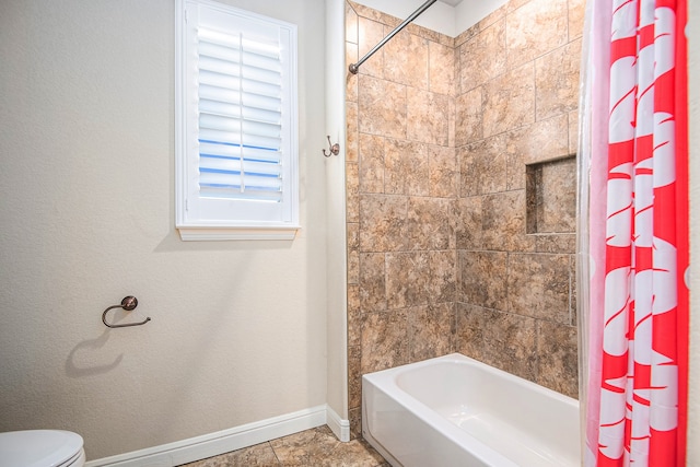 bathroom with shower / bath combination with curtain and toilet