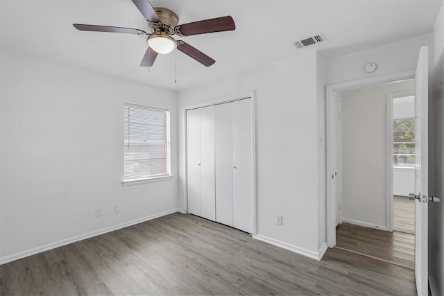 unfurnished bedroom featuring a closet, ceiling fan, and hardwood / wood-style flooring