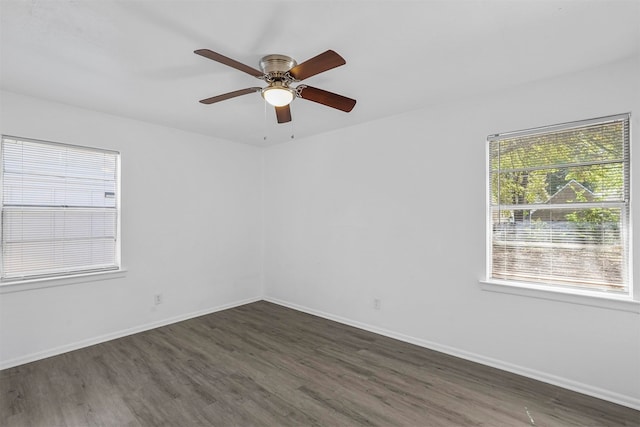 spare room featuring ceiling fan and dark hardwood / wood-style flooring