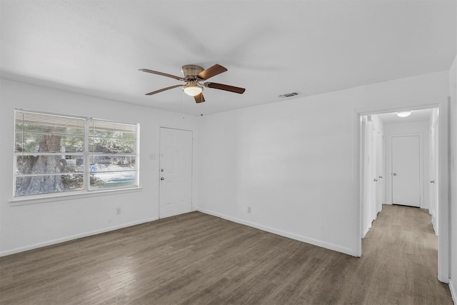 spare room featuring wood-type flooring and ceiling fan