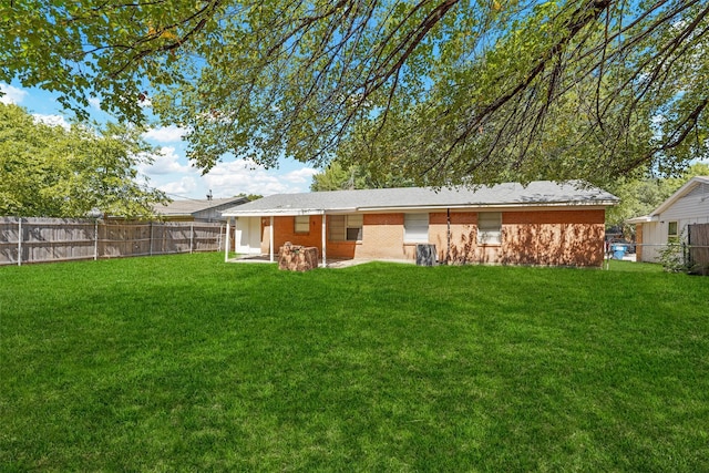 rear view of house with a yard