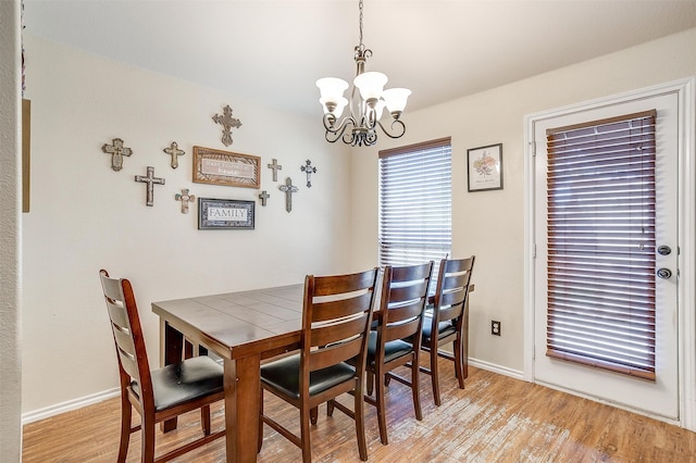 dining room featuring light hardwood / wood-style floors and an inviting chandelier