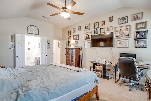 bedroom with vaulted ceiling, ceiling fan, carpet floors, and ensuite bathroom