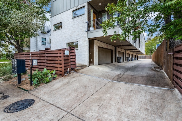 view of side of property with a balcony and a garage