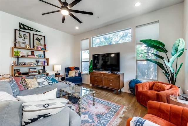 living room featuring light wood-type flooring and ceiling fan