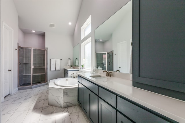 bathroom with vaulted ceiling, independent shower and bath, and vanity