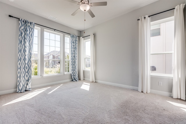 spare room featuring ceiling fan and light colored carpet