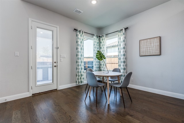 dining space featuring dark wood-type flooring