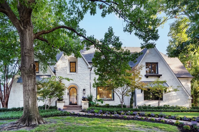 tudor house featuring a front lawn