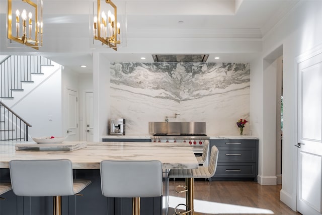 interior space featuring a kitchen breakfast bar, light stone counters, hanging light fixtures, and dark hardwood / wood-style floors