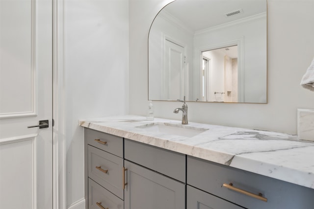 bathroom with vanity and ornamental molding