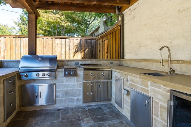 view of patio featuring area for grilling, a grill, sink, and wine cooler