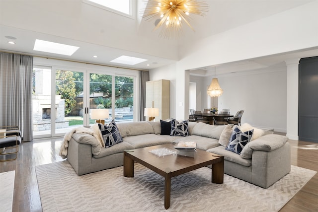 living room with hardwood / wood-style floors, a chandelier, and ornamental molding