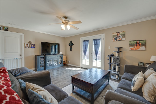 living room featuring ceiling fan, french doors, crown molding, and light wood-type flooring