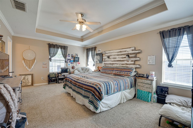 bedroom featuring carpet flooring, ceiling fan, a raised ceiling, and crown molding