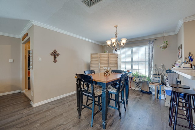 dining area featuring an inviting chandelier, dark hardwood / wood-style floors, and ornamental molding