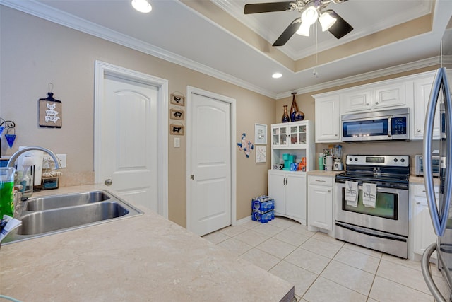 kitchen featuring a raised ceiling, sink, white cabinets, and stainless steel appliances