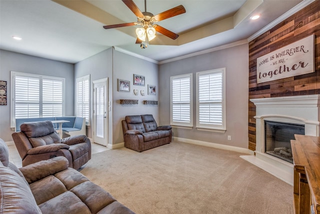 carpeted living room featuring a tray ceiling, ceiling fan, and plenty of natural light