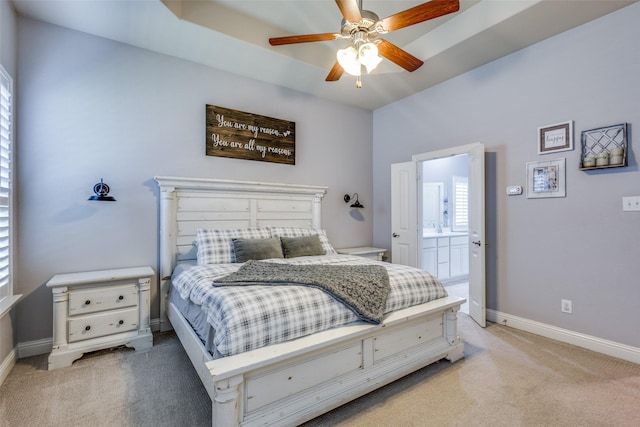 carpeted bedroom with connected bathroom and ceiling fan