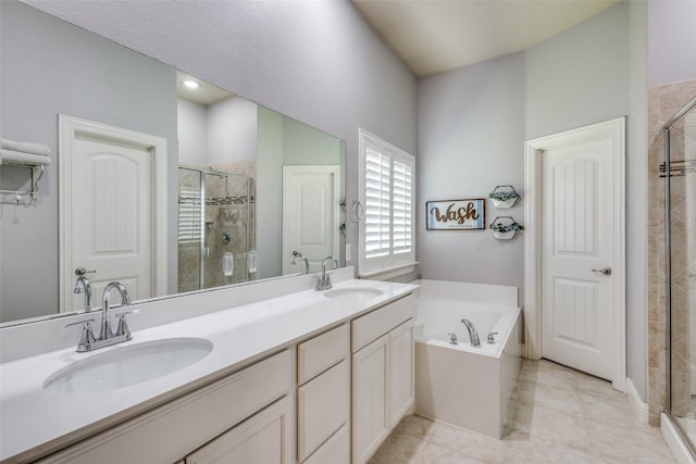 bathroom with tile patterned flooring, vanity, and shower with separate bathtub