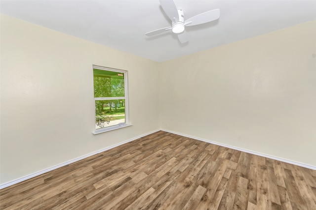 spare room with wood-type flooring and ceiling fan