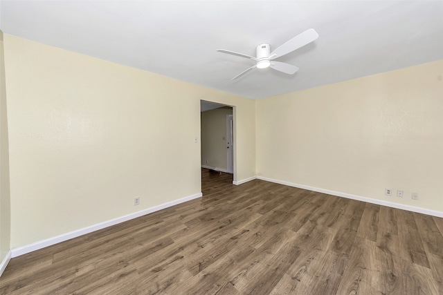 empty room featuring ceiling fan and dark wood-type flooring