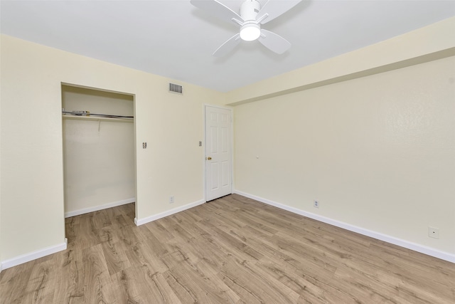 unfurnished bedroom featuring ceiling fan, a closet, and light hardwood / wood-style flooring