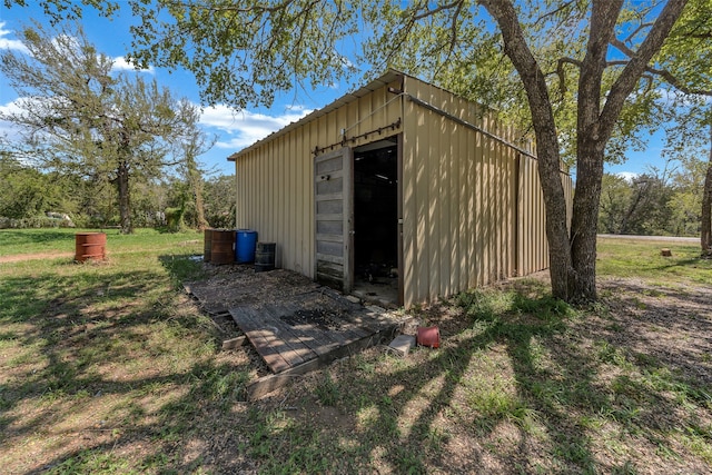 view of outbuilding featuring a lawn