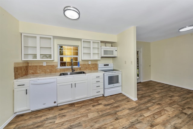 kitchen with white appliances, dark hardwood / wood-style floors, white cabinetry, and sink