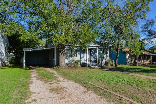 obstructed view of property with a carport and a front lawn