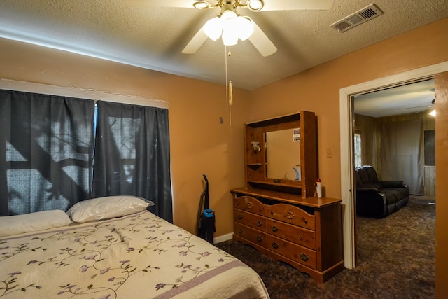 carpeted bedroom featuring a textured ceiling and ceiling fan