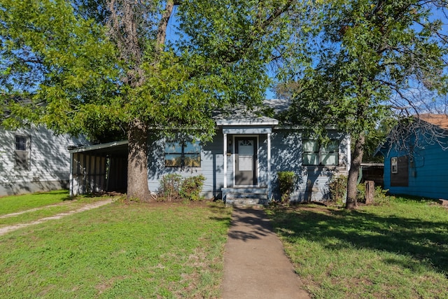 view of front of house featuring a front lawn and a carport