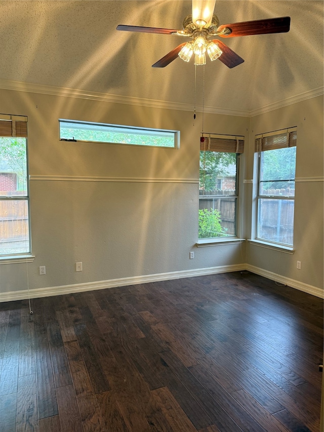 spare room featuring a textured ceiling, a healthy amount of sunlight, ceiling fan, and dark hardwood / wood-style floors